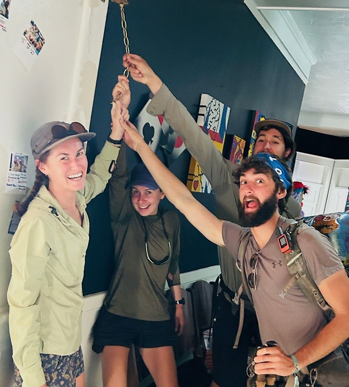 Pacific Crest Trail hikers ringing the bell at the Columbia Hotel 