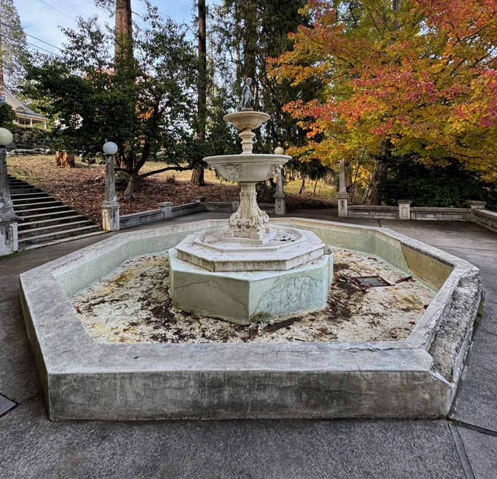 Historic fountain in a park that is in need of repair 